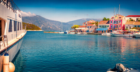 Sunny summer cityscape of Fiskardo port. Wonderful morning seascape of Ionian Sea. Stunning  outdoor scene of Kefalonia island, Greece, Europe. Traveling concept background.