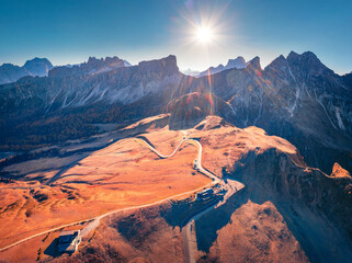Splendid aitumn view from flying drone of winding Giau pass road. Fmazing morning scene of Dolomite Alps, Belluno province, Italy, Europe. Traveling concept background.