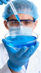 Scientist in a lab coat, gloves, and protective eyewear, carefully dispensing blue liquid into a petri dish.