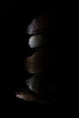 Dark Rock Stone Stack Side Lit Vertical Pile.