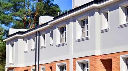 Newly built terraced houses in a residential area. Modern terraced houses on the outskirts of the city.