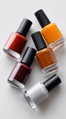 Assortment of colorful nail polish bottles displaying vibrant hues for fashion, beauty, manicure, and cosmetic concepts on a clean background