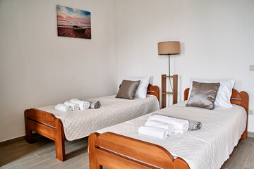 Bright and Inviting Guestroom with Two Twin Beds, Cozy Linen, and Contemporary Decor for Relaxing Stay