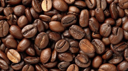 Naklejka premium Roasted coffee beans are displayed in a arrangement, showcasing their textures and shades of brown, representing a popular beverage ingredient. The macro shot highlights the surface details.