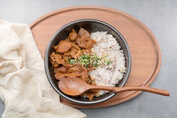 Jeyukdeopbap, Korean Food Spicy Stir-fried Pork with Rice in Black Bowl 
