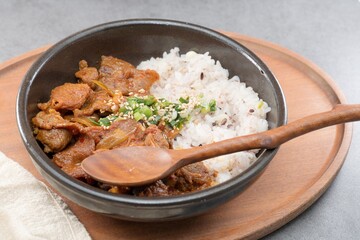 Jeyukdeopbap, Korean Food Spicy Stir-fried Pork with Rice in Black Bowl 
