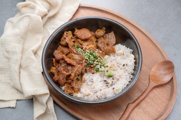 Jeyukdeopbap, Korean Food Spicy Stir-fried Pork with Rice in Black Bowl 
