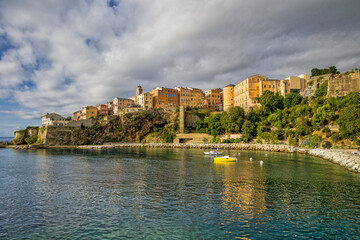 Fototapeta premium Bastia view from the old harbor to the citadel with colorful buildings in the warm morning sunlight