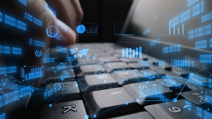 This image shows a close-up of hands typing on a laptop keyboard with digital graphs and data visualizations overlay, illustrating the integration of technology and analytics. Xenic