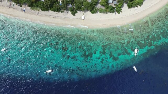 Aerial view of tropical island Balicasag beach, turquoise waters and coral reefs, Philippines, 4k
