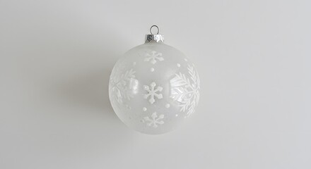 Frosted holiday sphere ornament with decorative snowflake designs, reflecting winter's beauty & seasonal cheer