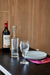 A Tasteful Table Setting Featuring Wine, Water, and Elegant Glassware with a Simple Plate, Perfect for an Intimate Dinner or Celebration