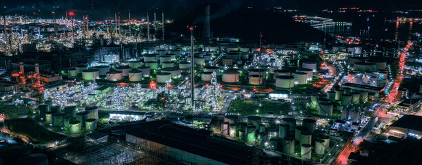 Factory-oil and gas industry, Oil refinery industrial plant at night, oil and gas chemical tank with oil refinery plant background at twilight, business power and energy chemical barrel