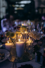 Elegant Candlelit Table Setting with Fresh Flowers and Delicious Treats, Perfect for Special Occasions and Memorable Gatherings with Family and Friends