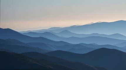 Fototapeta premium Layers of blue mountains in the distance at sunrise in the wilderness