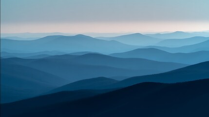 Fototapeta premium Layers of blue mountains in the distance at sunrise in the wilderness