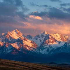 Mountain landscape of snow-capped mountains in the mist.
