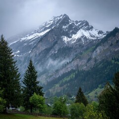 Mountain landscape of snow-capped mountains in the mist.
