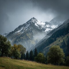 Mountain landscape of snow-capped mountains in the mist.
