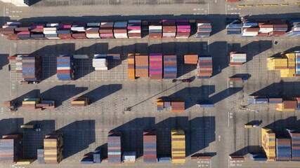 Oakland, United States - 02 September 2025: Aerial view of a kaleidoscope of shipping containers casting stark shadows, a symphony of industrial hues by the waterfront at 530 Water Street.