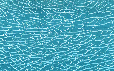 Cracked glass texture creating abstract blue pattern