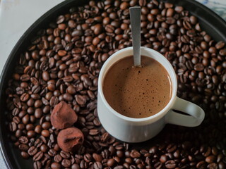top-down view of a coffee cup - Still Life of a Fresh Coffee with Two Chocolate Truffles
