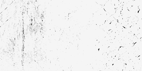 Abstract monochrome texture with grunge effect and scattered dark speckles and scratches on white background