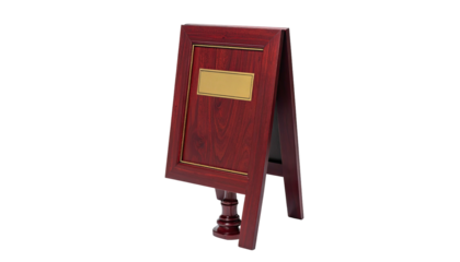 A wooden A-frame sign with a blank gold plaque, elegantly designed, against black