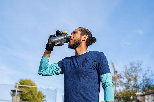Thirsty athlete drinking water