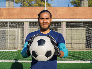 Goalkeeper posing with soccer ball
