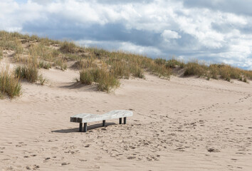 Sand, beach and a bench for resting