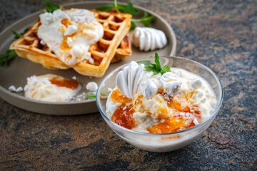 Creme chiboust - pastry  and meringue cream with apricot jam topping servied as close-up with fresh...