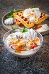 Creme chiboust - pastry  and meringue cream with apricot jam topping servied as close-up with fresh brussels waffles
