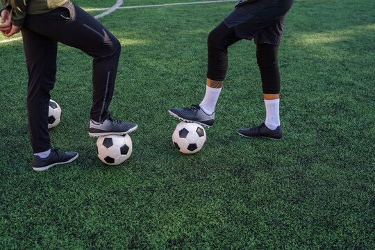 Soccer player touching balls with feet