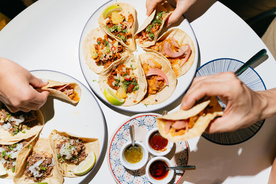 People Enjoying Delicious Mexican Tacos