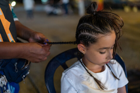 Young Girl Getting Braids In Resort City Evening