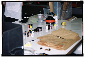 Film rolls and developing equipment on photography workspace
