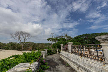 Walkway with a fence and a tree in the background