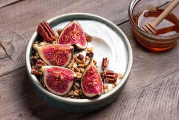 Granola breakfast bowl with figs and pecan nuts