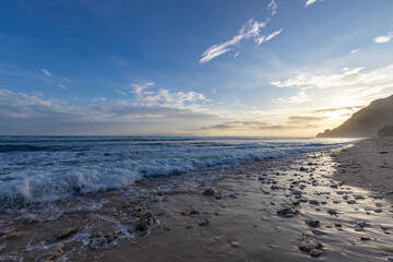 The ocean is calm and the sky is blue