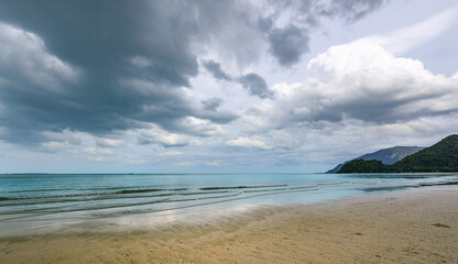 Cloudy day at the beach with the ocean in the background