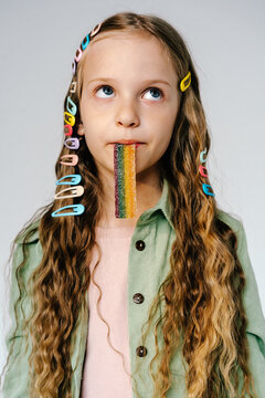Girl with rainbow candy strip and colorful hair clips