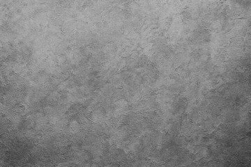 A close-up view of a textured gray surface with subtle variations in shading. The texture is uniform and appears similar to concrete or stone.AI generated.