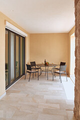 Cozy Outdoor Seating Area with a Table, Chairs, and Refreshments, Perfect for Relaxation and Enjoying Scenic Views in an Inviting Atmosphere