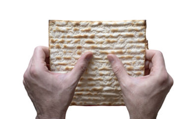 Close-up of two hands holding a matzah during the Jewish celebration of Passover. Isolated, png.