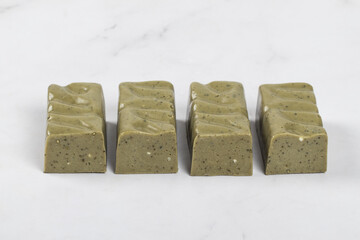 Green tea matcha candy. White background. Close-up	