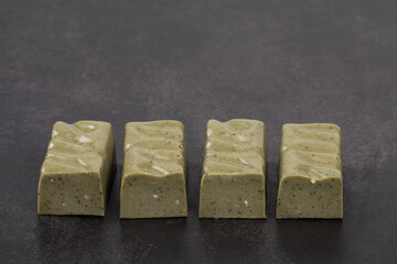 Vegan Green tea matcha candy. Dark background. Copy space