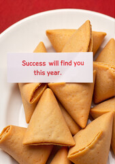 Fortune cookies with motivational message on white plate for Lunar New Year  