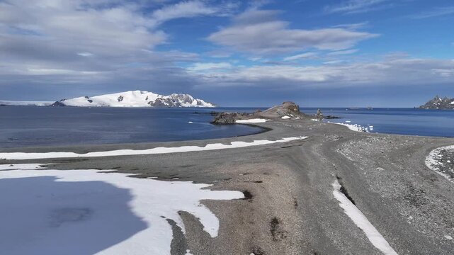 Breathtaking winter Arctic aerial sunset landscape. Frozen beauty Antarctica nature. Colorful clouds sky reflected in Polar frozen ocean water. Snow covered mountain, glacier, iceberg. Travel, explore