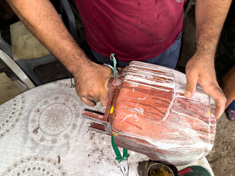 A man is repairing a paint machine.